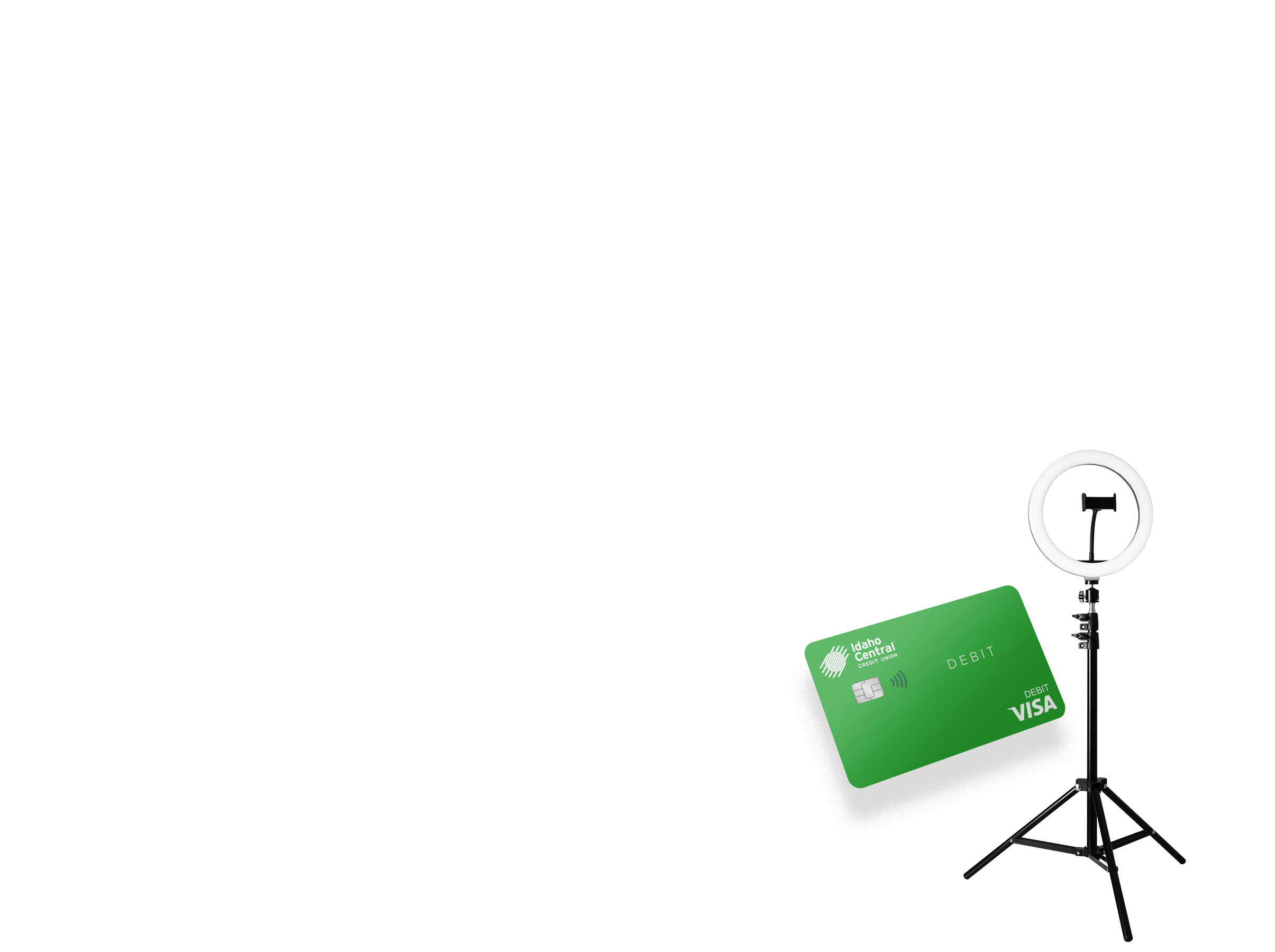 Green ICCU debit card floating in the foreground and a ring light on a stand