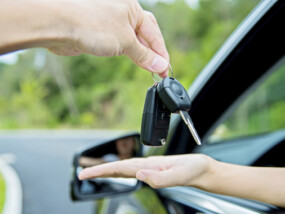 Woman hand receiving car key.