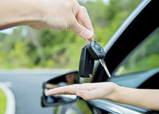 Woman hand receiving car key.