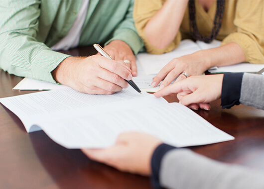 Couple Completing ARM loan application with ICCU loan officer