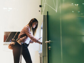 Woman taking money out of an ATM.