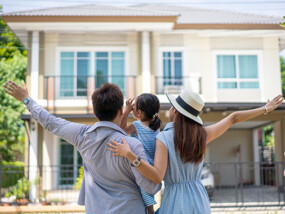 Family in front of new home