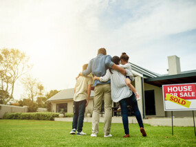 Family in front of new home.