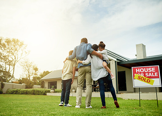 Family in front of new home.