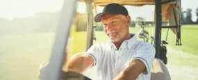 Retired man driving a golf cart