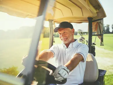 Retired man driving a golf cart
