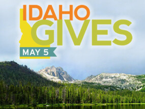Idaho Gives Logo over mountain scene.