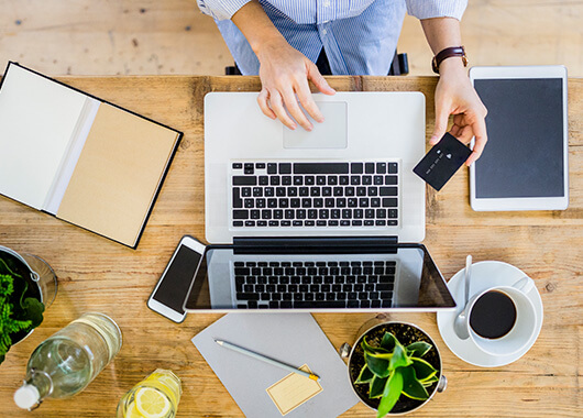 Woman at laptop with credit card