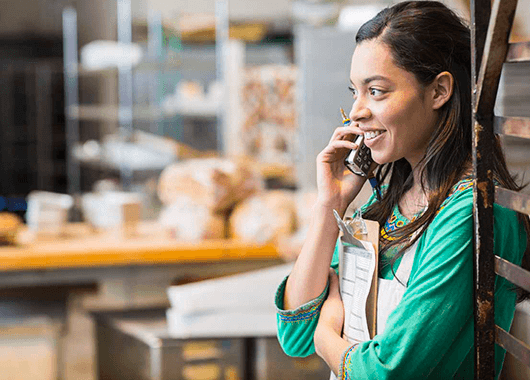 Woman talking on the phone in green shirt