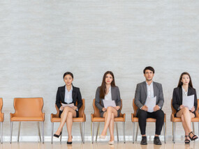 Four people sitting for a job interview