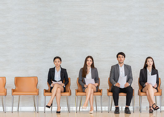 Four people sitting for a job interview