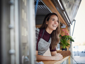Small business owner smiling in food truck