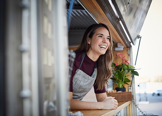 Small business owner smiling in food truck