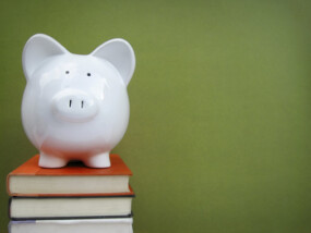 Piggy bank on top of stack of books.