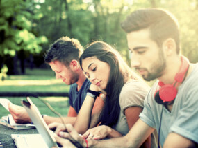 group of young adults studying outdoors