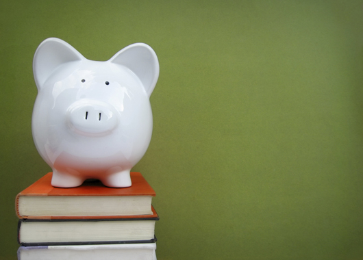 Piggy bank on top of stack of books.