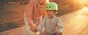 Mom showing son how to ride a bike