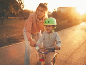 Mom showing son how to ride a bike