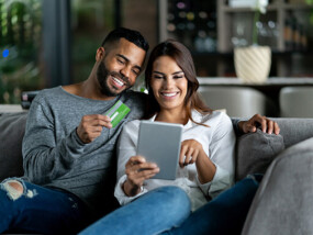 Couple using credit card for online purchase