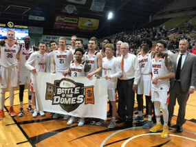 Idaho State University Basketball Players with Battle of the Domes sign