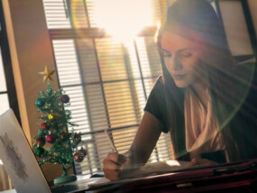 Woman looking at paperwork and computer