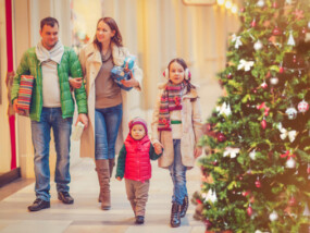 Family buying Christmas gifts in a shopping mall