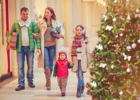 Family buying Christmas gifts in a shopping mall