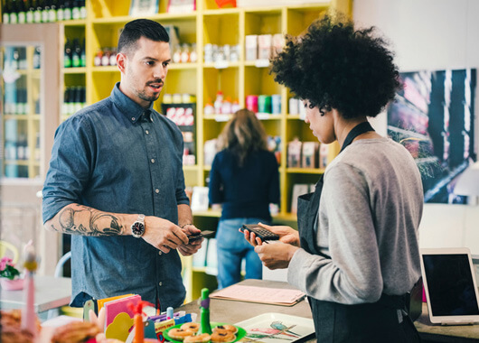 Man paying for his goods at retail store.