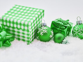 Green Presents and Christmas Ornaments on a White Bed of Snow