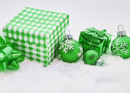 Green Presents and Christmas Ornaments on a White Bed of Snow