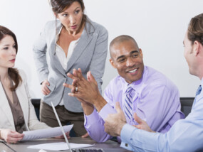 Multi-ethnic group of business people meeting in board room.