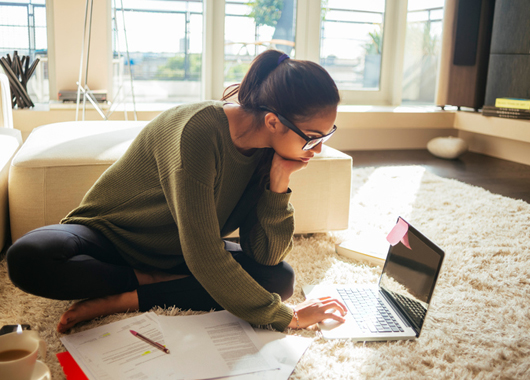 Woman on her computer reviewing her finances.