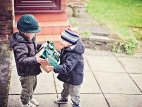 Child giving a present to his little brother