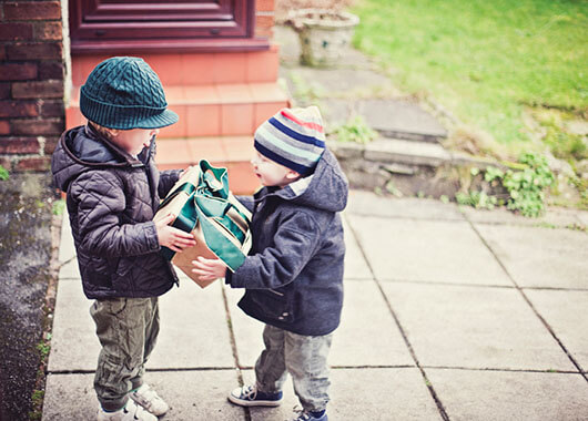 Child giving a present to his little brother