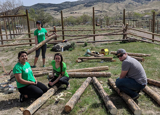ICCU Team Members Volunteering Making Fences at the Zoo|Idaho Central team members presenting a check to the Hispanic Chamber of Commerce.