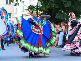 Hispanic women walking in parade.