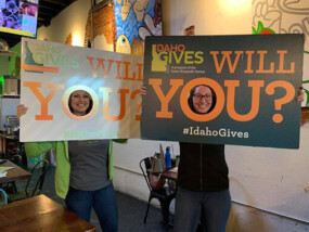 ICCU employees in front of an Idaho Gives sign.