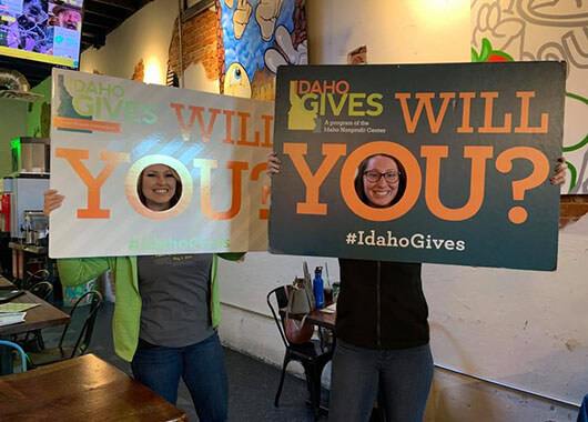 ICCU employees in front of an Idaho Gives sign.