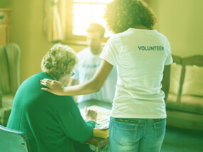 volunteer helping older woman