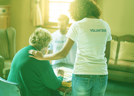 volunteer helping older woman