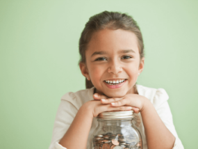 Happy girl with her jar of savings.