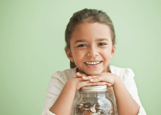 Happy girl with her jar of savings.