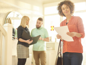 young couple viewing property with real estate agent