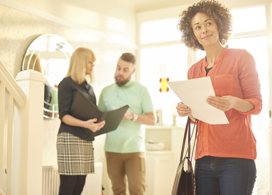 young couple viewing property with real estate agent