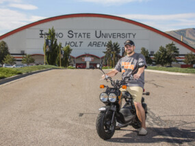 Lucky winner of a Honda Ruckus in front of Holt Arena in Pocatello