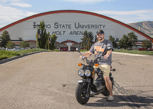 Lucky winner of a Honda Ruckus in front of Holt Arena in Pocatello