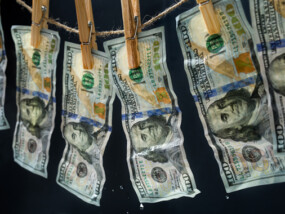 Laundered dollars hanging on a rope with clothespins