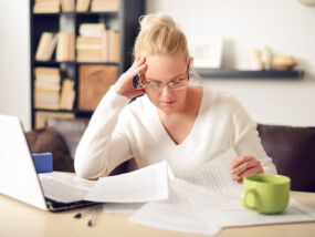 woman reviewing her taxes at her computer.