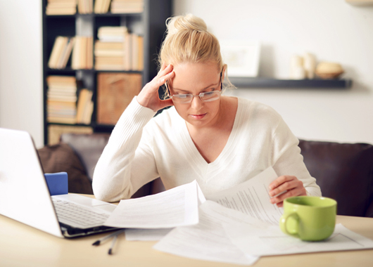 woman reviewing her taxes at her computer.