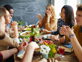 Group of intercultural friends having Thanksgiving dinner